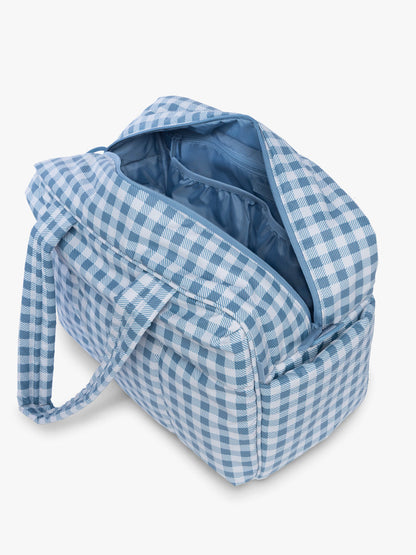 Opened view of CALPAK Luka Duffel in white and blue gingham print in French Blue Gingham; DSM1901-FRENCH-BLUE-GINGHAM