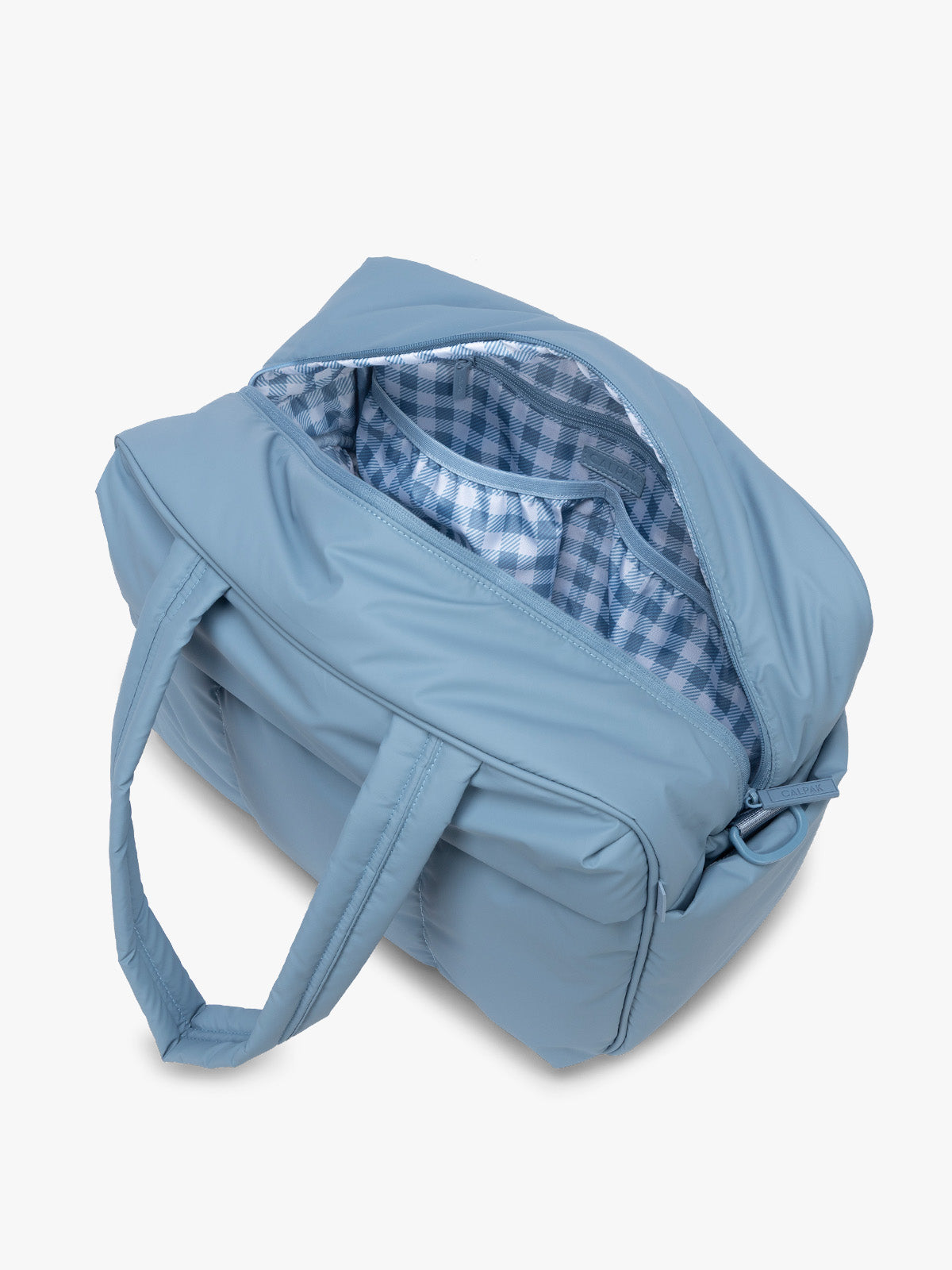 Opened view of CALPAK Luka Duffel in light blue French Blue with interior white and blue gingham print; DSM1901-FRENCH-BLUE