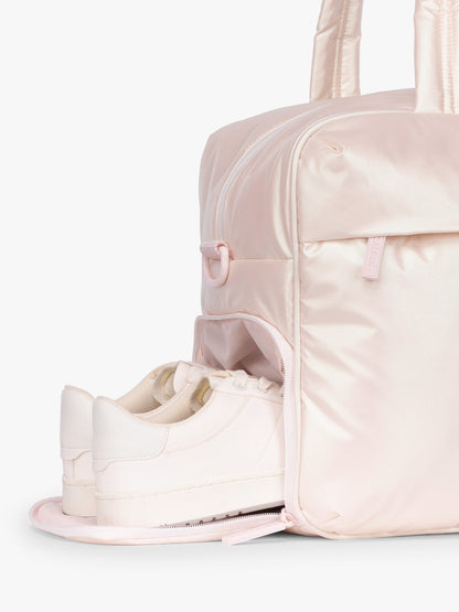 Shoe compartment of CALPAK Luka Duffel in light pink shiny Pearlescent; DSM1901-PEARLESCENT