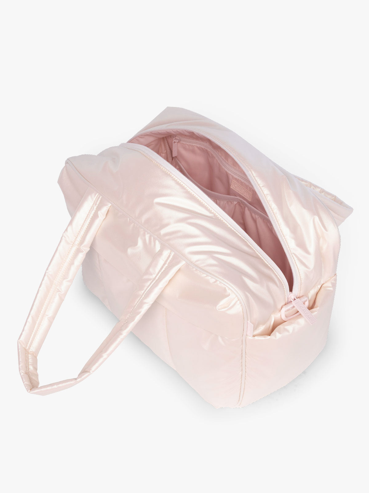 Opened CALPAK Luka Duffel in light pink shiny Pearlescent; DSM1901-PEARLESCENT