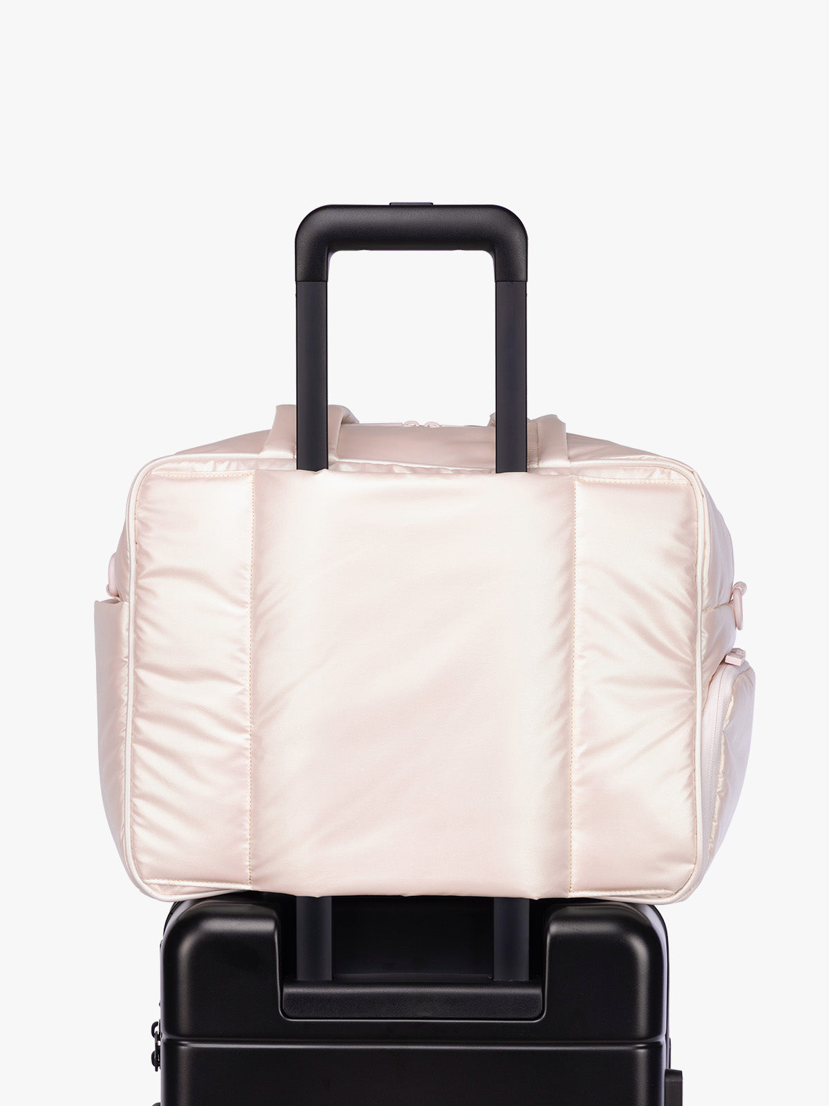 Luggage trolley sleeve of CALPAK Luka Duffel in light pink shiny Pearlescent; DSM1901-PEARLESCENT
