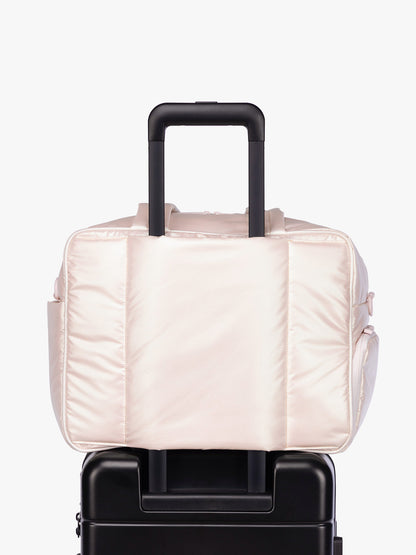 Luggage trolley sleeve of CALPAK Luka Duffel in light pink shiny Pearlescent; DSM1901-PEARLESCENT