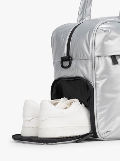 CALPAK Silver Luka Duffel side shoe compartment a white background; DSM1901-SILVER