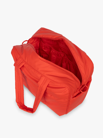Opened CALPAK Luka Duffel in red Tomato; DSM1901-TOMATO