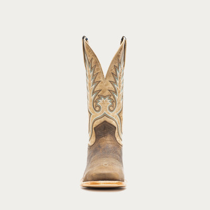 Brown and tan cowboy boot with intricate design on a light gray background