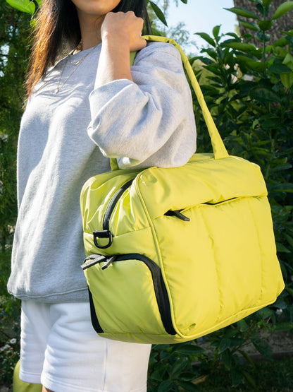 Model pictured with CALPAK Luka duffel bags in celery green and green apple; DSM1901-CELERY