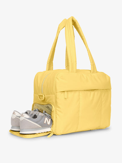 Shoe compartment of CALPAK Luka Duffel Bag in yellow; DSM1901-BUTTER