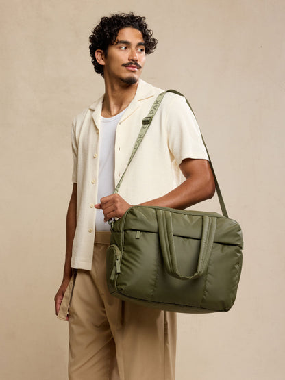 Male model wearing CALPAK Luka Duffel in dark green Pine; DSM1901-PINE