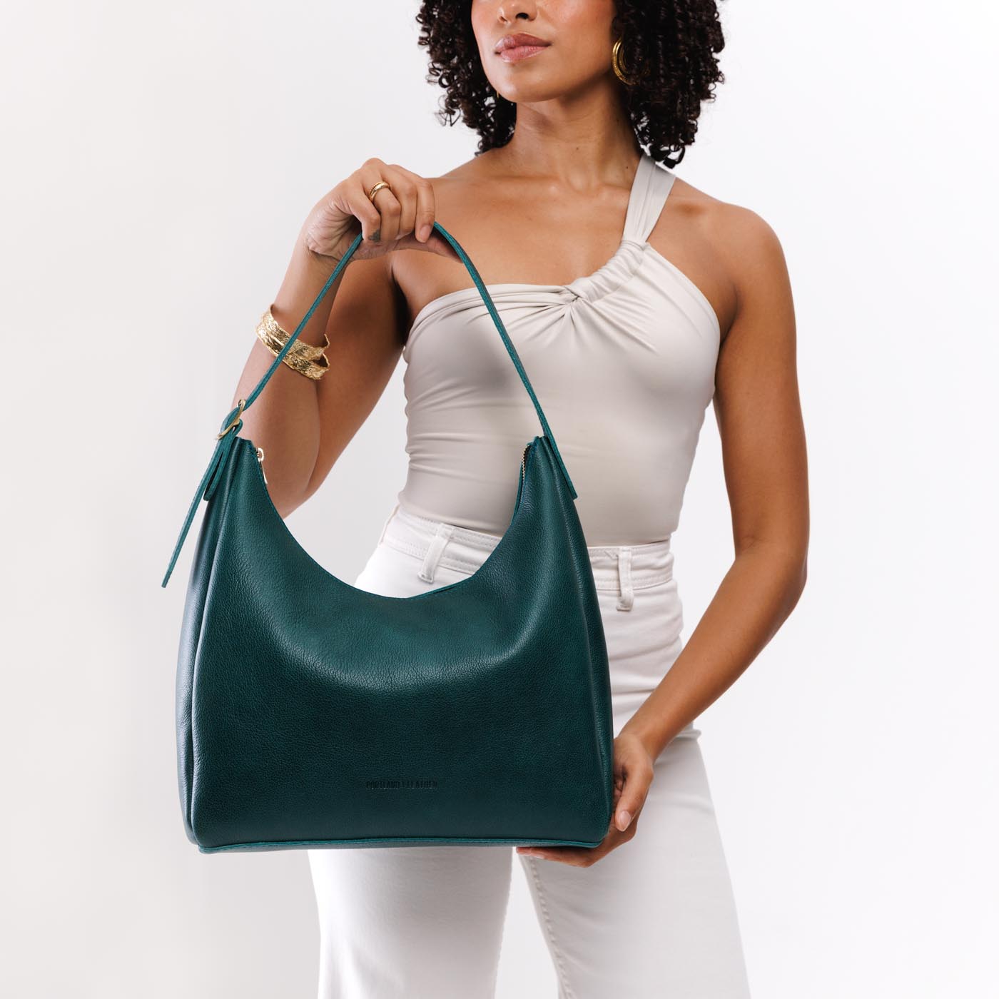 Sea Glass*Large | Model holding u-shaped, flat-bottomed leather shoulder bag with adjustable strap