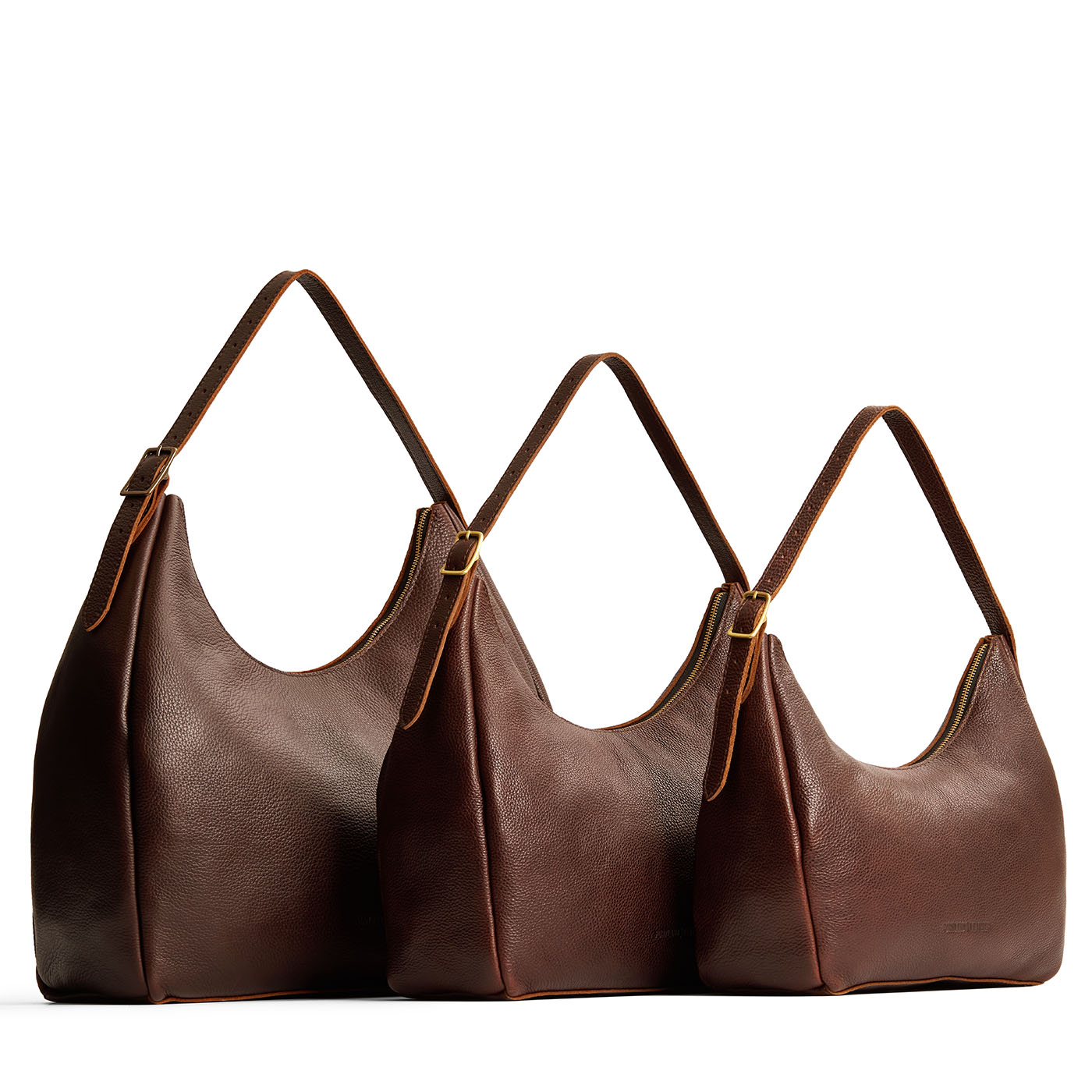 Coldbrew | Size comparison image of oversized, large, and medium u-shaped, flat-bottomed leather shoulder bags with adjustable strap