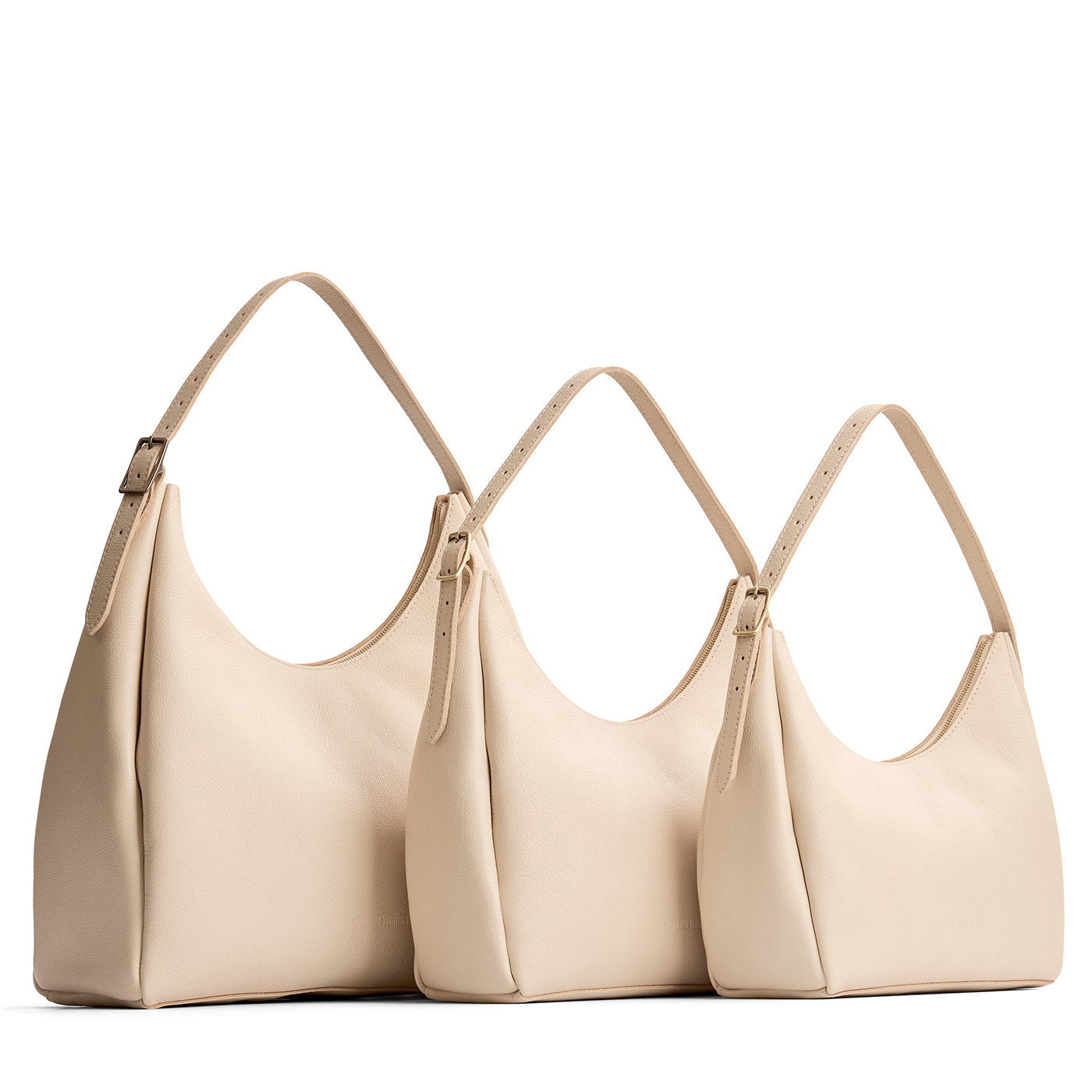 Pebbled Bone | Size comparison image of oversized, large, and medium u-shaped, flat-bottomed leather shoulder bags with adjustable strap